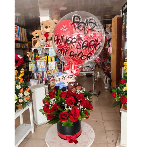 Caja cilíndrica con rosas rojas, globo “Feliz Aniversario” y peluches en Pereira