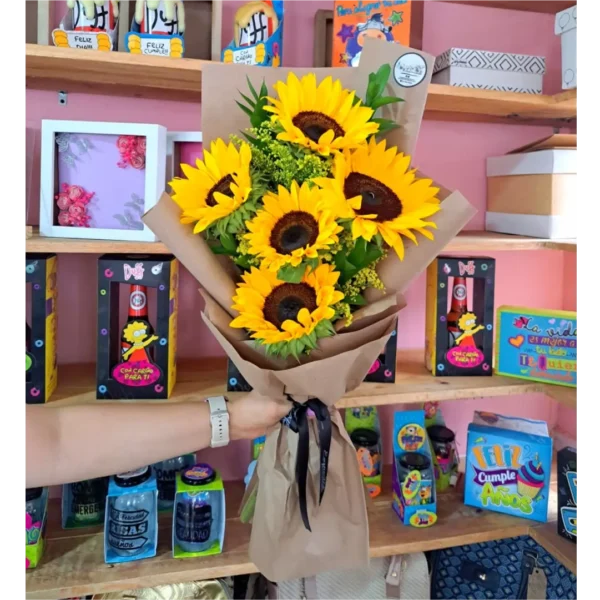 Bouquet engalanado de girasoles frescos envueltos en papel kraft con follaje verde