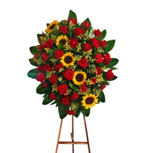 Arreglo floral de pie con rosas rojas y girasoles para condolencias